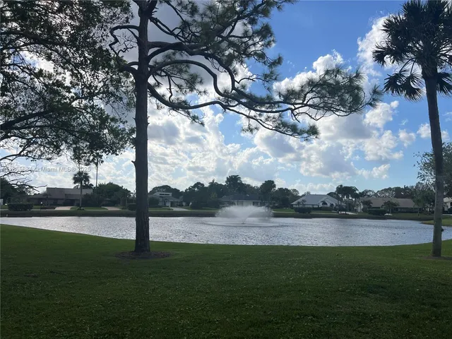 a view of a livingroom with furniture and a floor to ceiling window