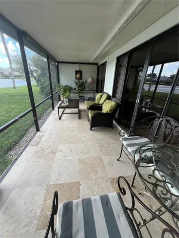 a dining hall with furniture a window and appliances