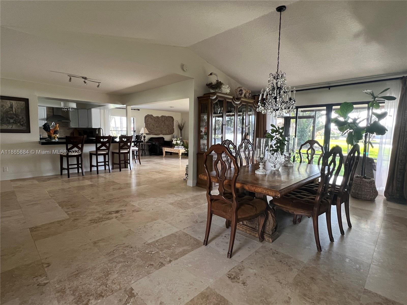 6198 Brandon Street, Unit 6198 Palm Beach Gardens, FL 33418 - Photo 8 of 26 a view of a dining room with furniture window and outside view