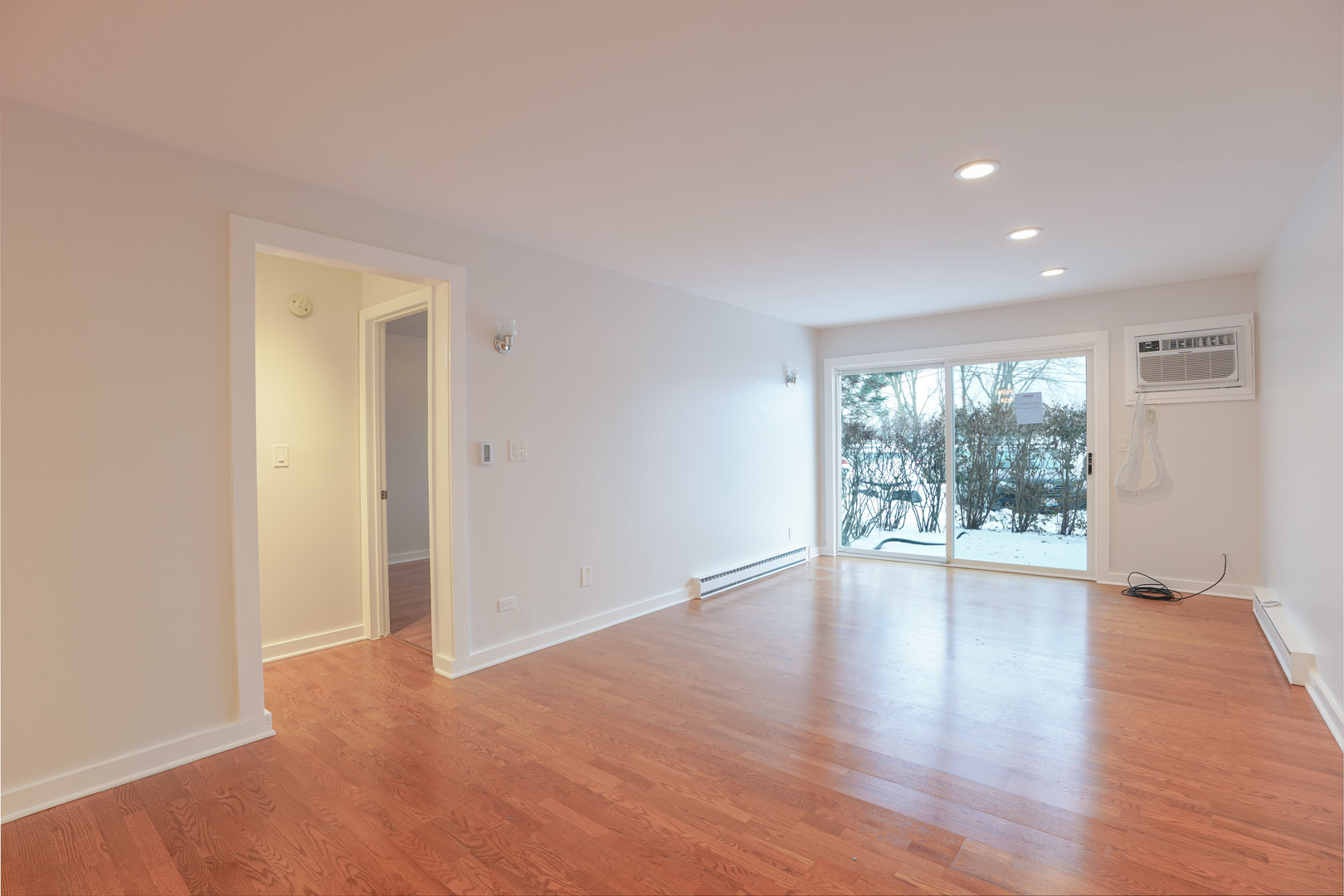 816 East Old Willow Road, Unit 112 Prospect Heights, IL 60070 - Photo 4 of 17 a view of an empty room with wooden floor and a window