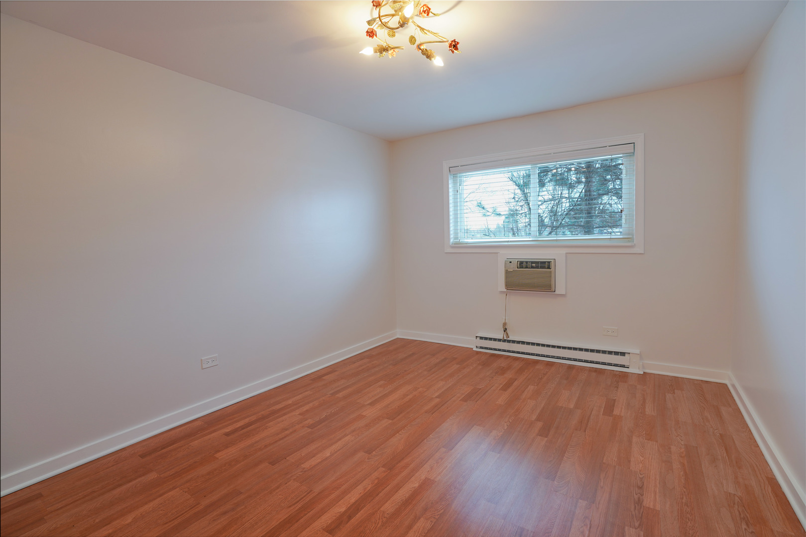 816 East Old Willow Road, Unit 112 Prospect Heights, IL 60070 - Photo 10 of 17 wooden floor in an empty room with a window