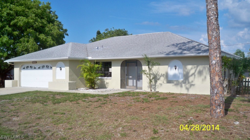 17513 Fuchsia Road Fort Myers, FL 33967 - Photo 1 of 12 a front view of a house with garden