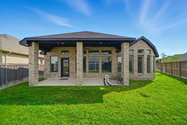 a front view of a house with a yard and porch