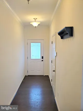 an empty room with wooden floor and mirror