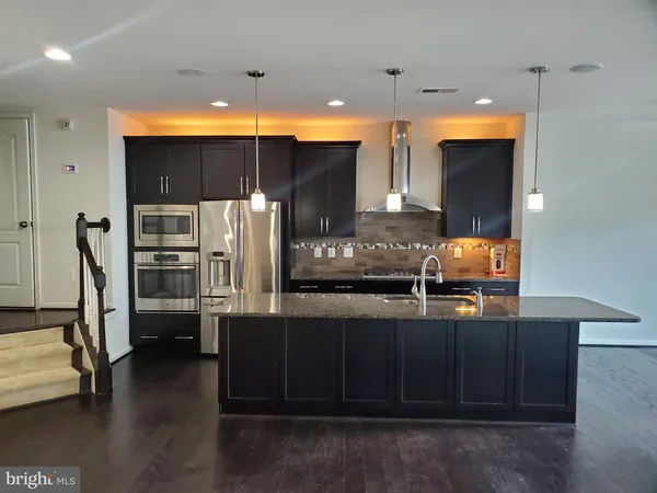 a kitchen with stainless steel appliances a refrigerator and a stove