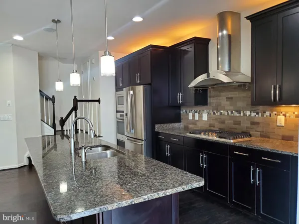 a kitchen with refrigerator and cabinets