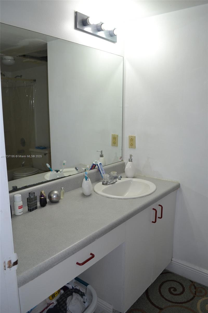 15201 Southwest 80th Street, Unit 207 Miami, FL 33193 - Photo 15 of 23 a bathroom with a sink and a mirror
