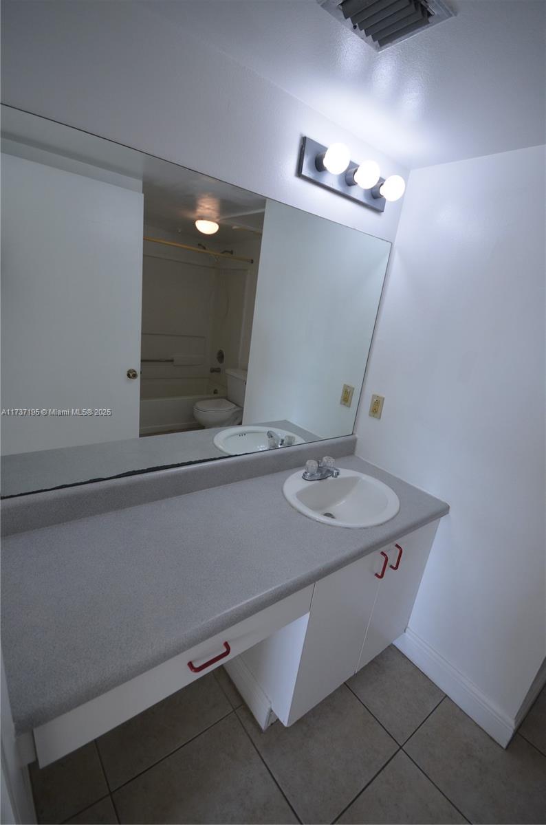 15201 Southwest 80th Street, Unit 207 Miami, FL 33193 - Photo 18 of 23 a bathroom with a sink and a mirror