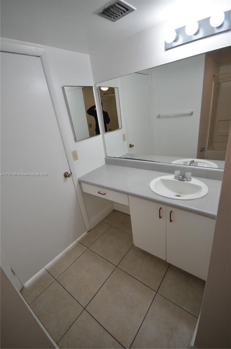 15201 Southwest 80th Street, Unit 207 Miami, FL 33193 - Photo 20 of 23 a bathroom with a sink and a mirror
