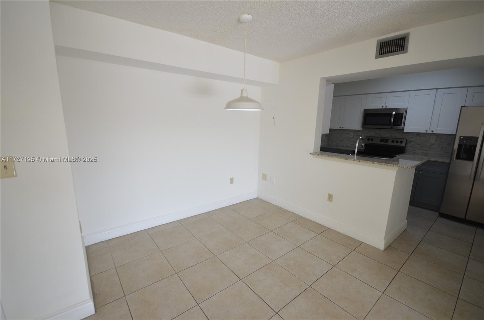 15201 Southwest 80th Street, Unit 207 Miami, FL 33193 - Photo 7 of 23 a kitchen with a sink and a refrigerator