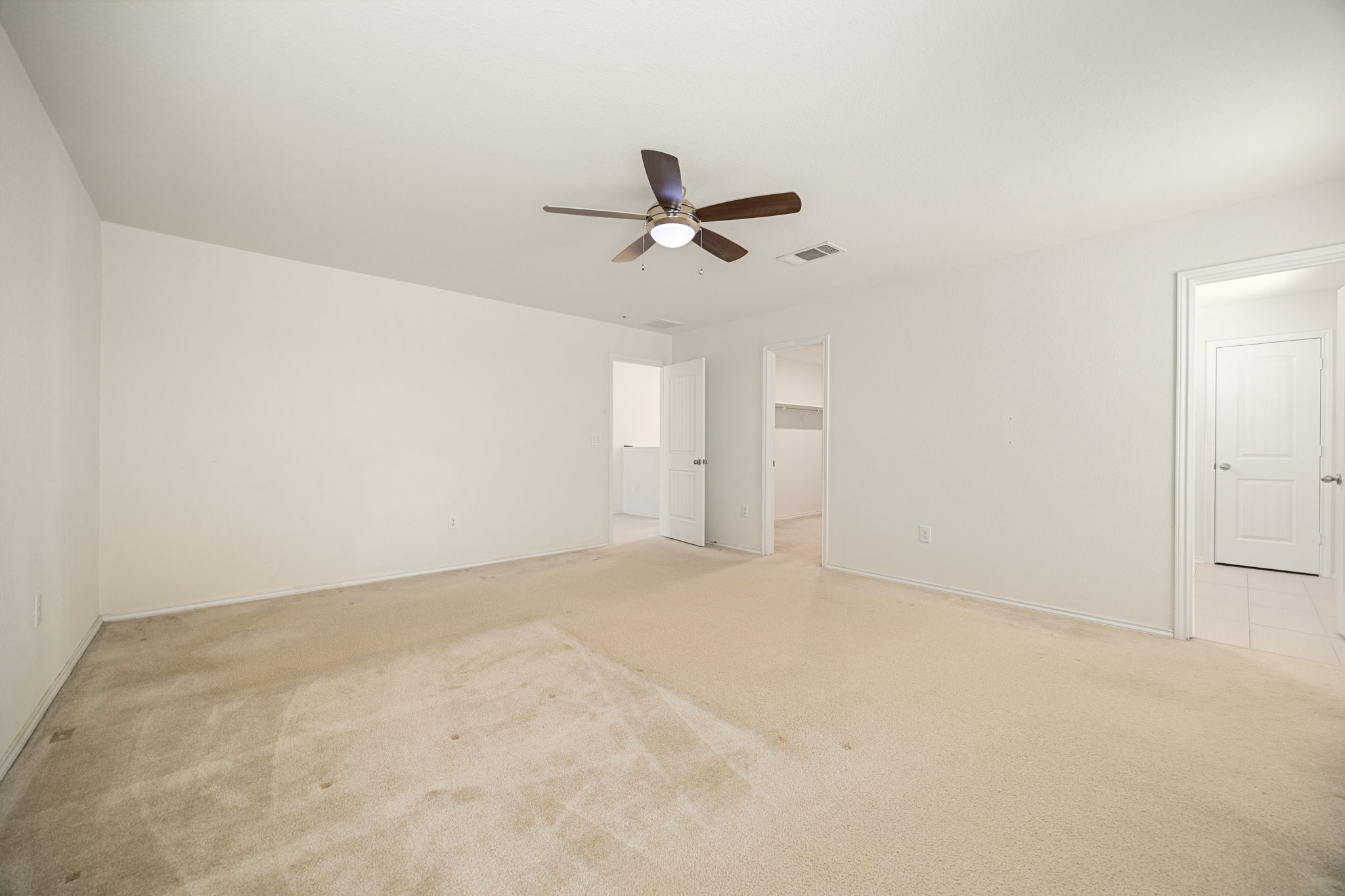 14615 Goshawk Drive Pflugerville, TX 78660 - Photo 16 of 29 an empty room with windows and fan