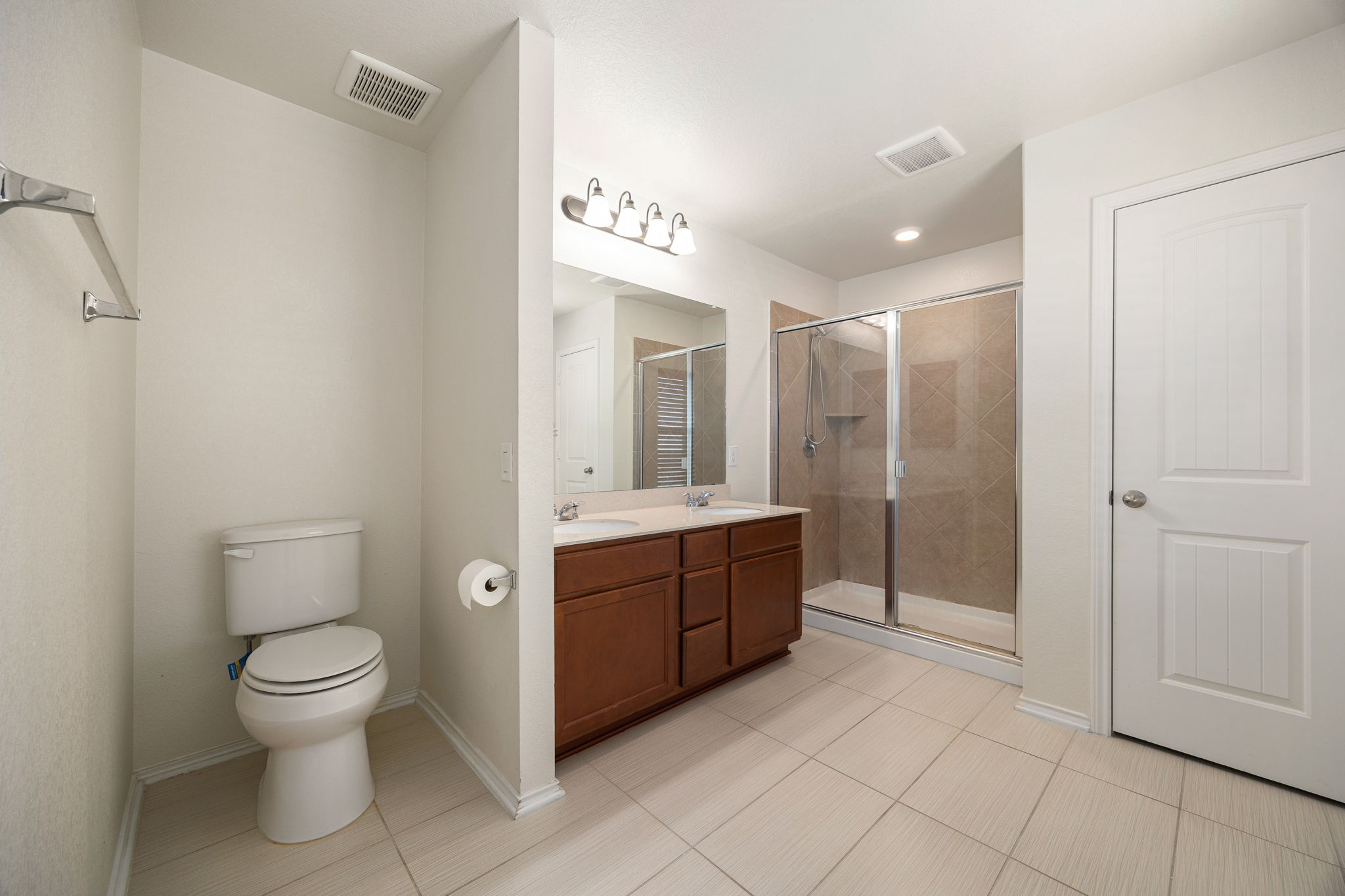 14615 Goshawk Drive Pflugerville, TX 78660 - Photo 17 of 29 a bathroom with a toilet sink and shower