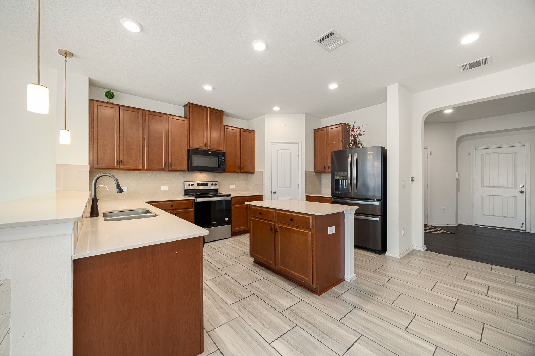 14615 Goshawk Drive Pflugerville, TX 78660 - Photo 7 of 29 a kitchen with stainless steel appliances granite countertop a sink stove and refrigerator