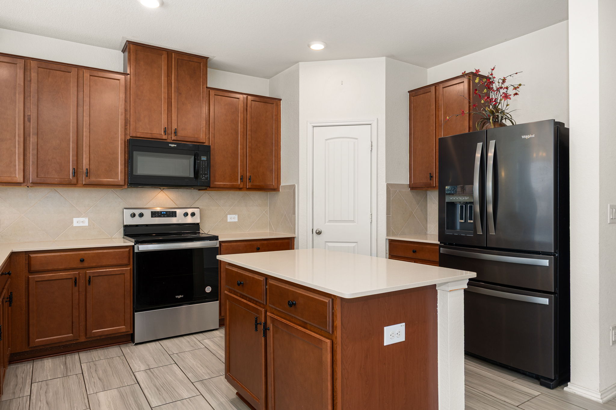 14615 Goshawk Drive Pflugerville, TX 78660 - Photo 9 of 29 a kitchen with stainless steel appliances granite countertop a refrigerator stove and microwave