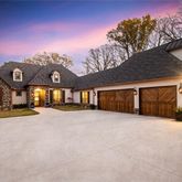 a view of a house with a yard and garage