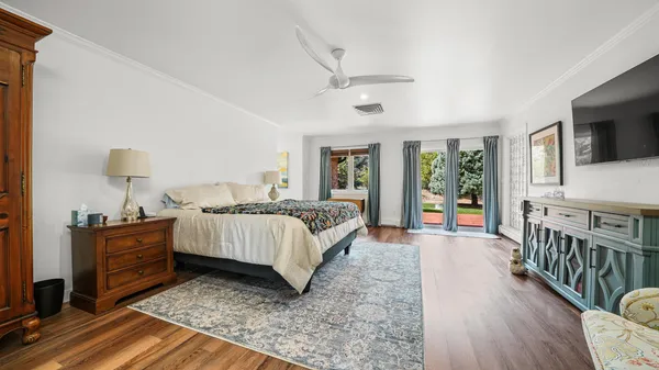 a bed room with furniture and a flat screen tv