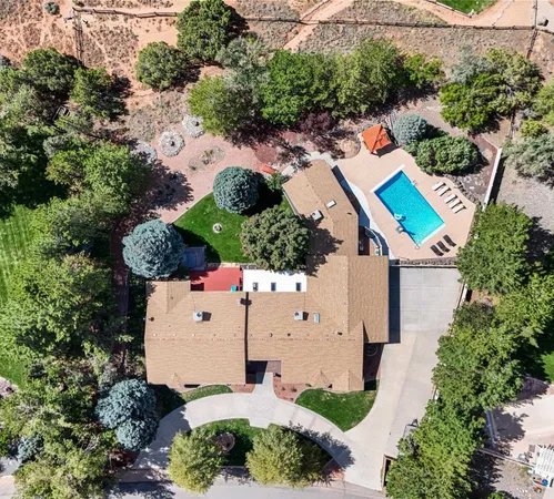 an aerial view of house with yard and swimming pool