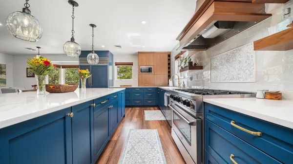 a kitchen with a stove and a chandelier