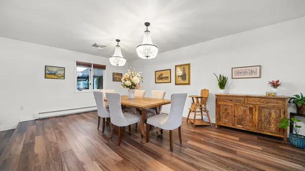 a view of a dining room with furniture and wooden floor