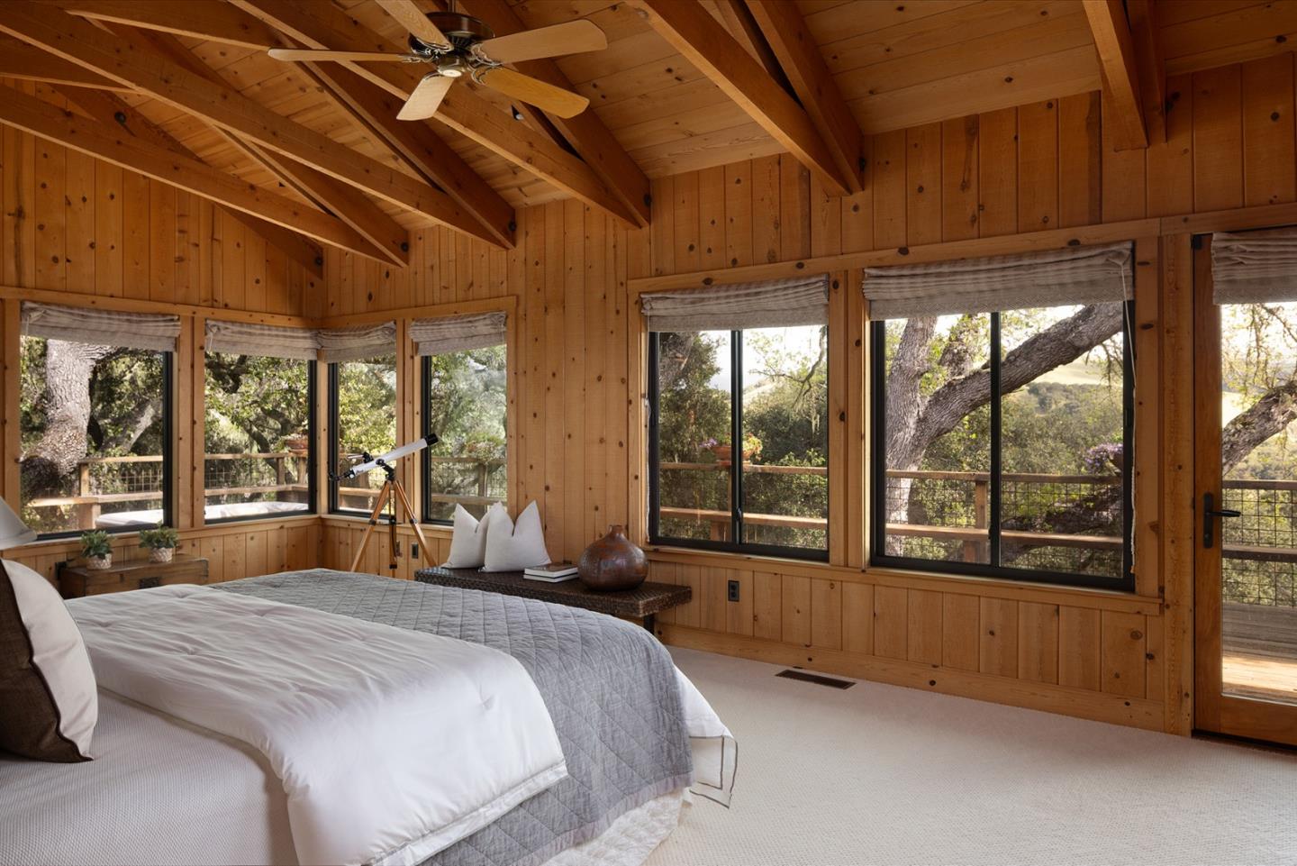 17094 Cachagua Road Carmel Valley, CA 93924 - Photo 14 of 42 a bedroom with large bed and a large window