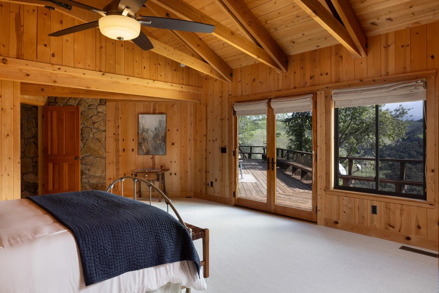 17094 Cachagua Road Carmel Valley, CA 93924 - Photo 20 of 42 a bedroom with a bed and a large window