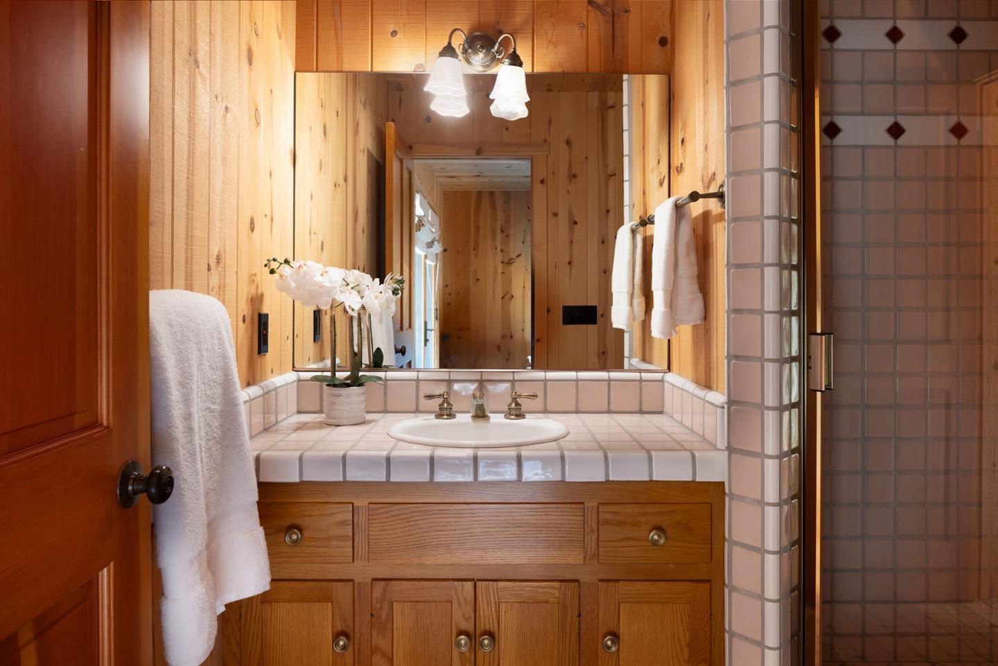 17094 Cachagua Road Carmel Valley, CA 93924 - Photo 28 of 42 a bathroom with a granite countertop sink and a mirror