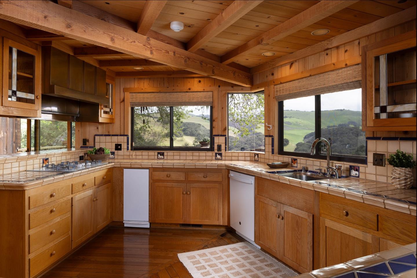 17094 Cachagua Road Carmel Valley, CA 93924 - Photo 8 of 42 a kitchen with a sink window and cabinets
