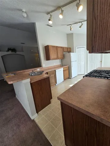 a kitchen with a stove and a refrigerator