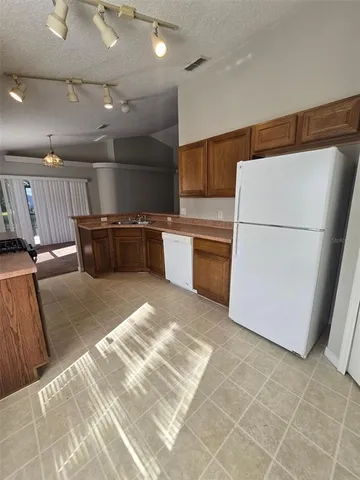 a kitchen with a cabinets and white appliances