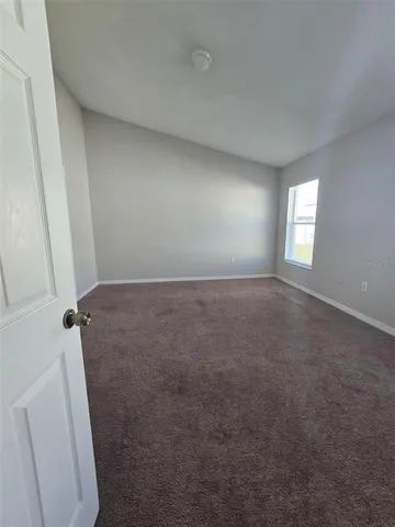 a view of room with window and hardwood floor