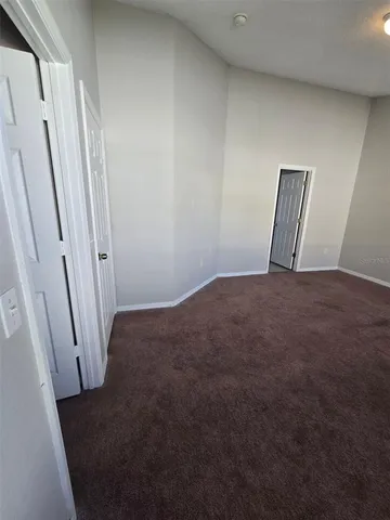 a view of an empty room and a window