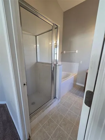 a bathroom with a tub a sink and a shower