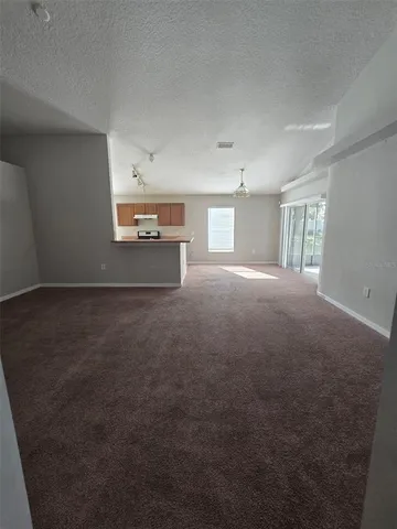 a view of a big room with windows and cabinet