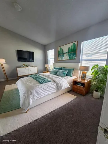 a bedroom with a bed and a flat screen tv