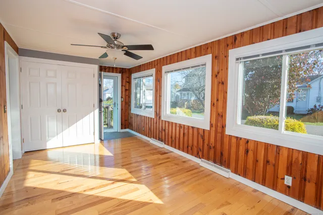 a view of a room with wooden floor and windows