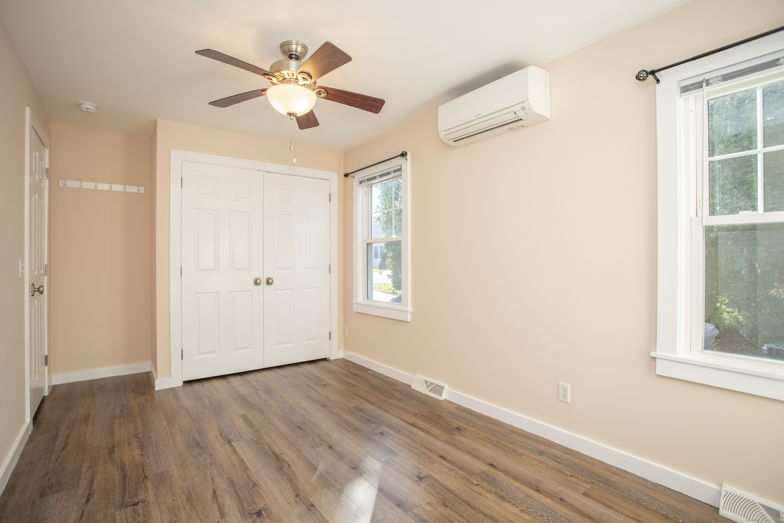 10 Dorothy Road Westbrook, CT 06498 - Photo 16 of 25 an empty room with wooden floor chandelier fan and windows
