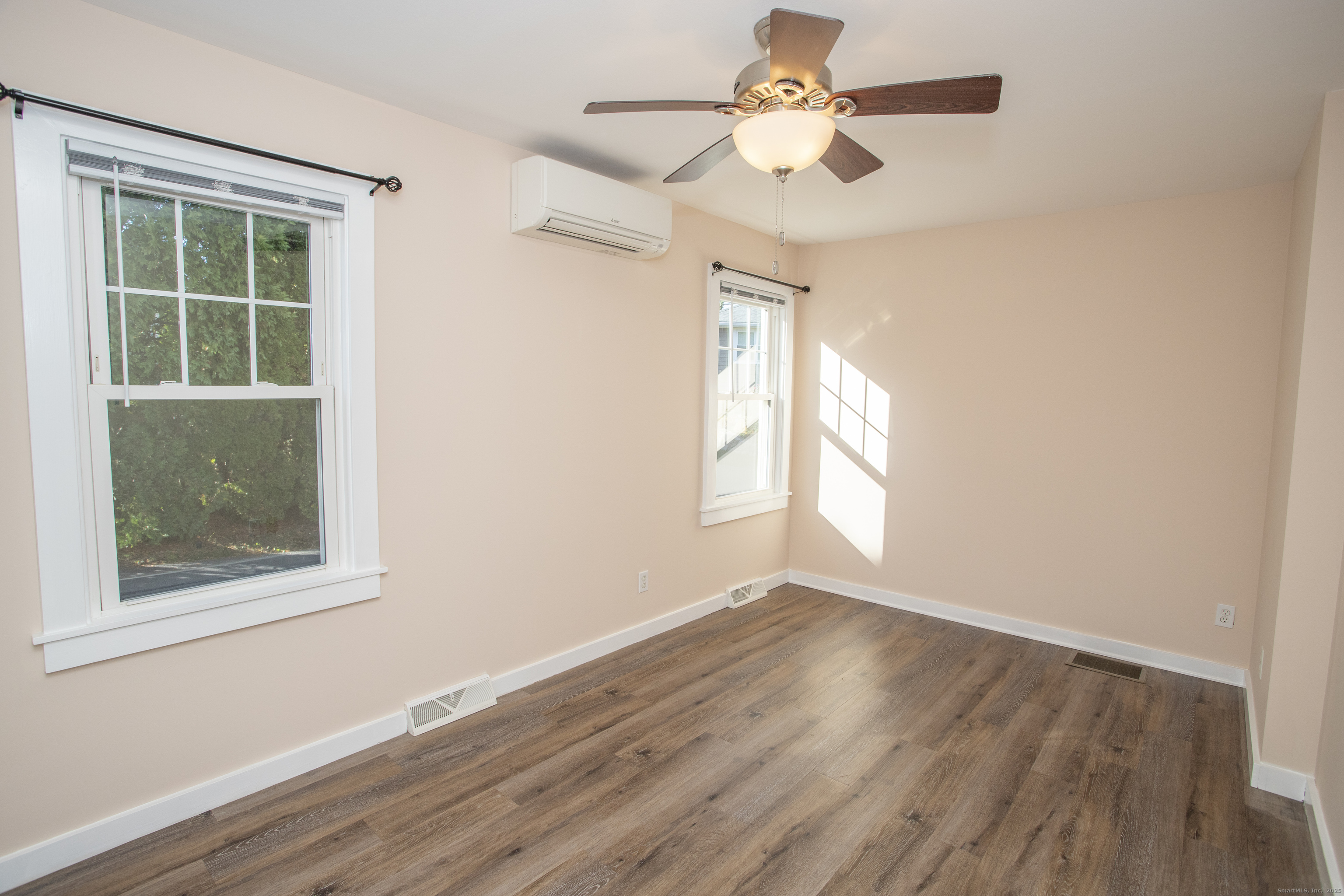 10 Dorothy Road Westbrook, CT 06498 - Photo 17 of 25 an empty room with wooden floor chandelier fan and windows