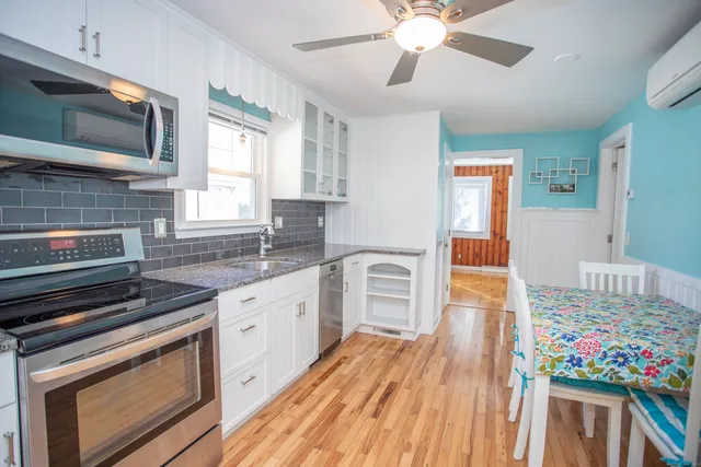 a kitchen with stainless steel appliances granite countertop a stove and cabinets