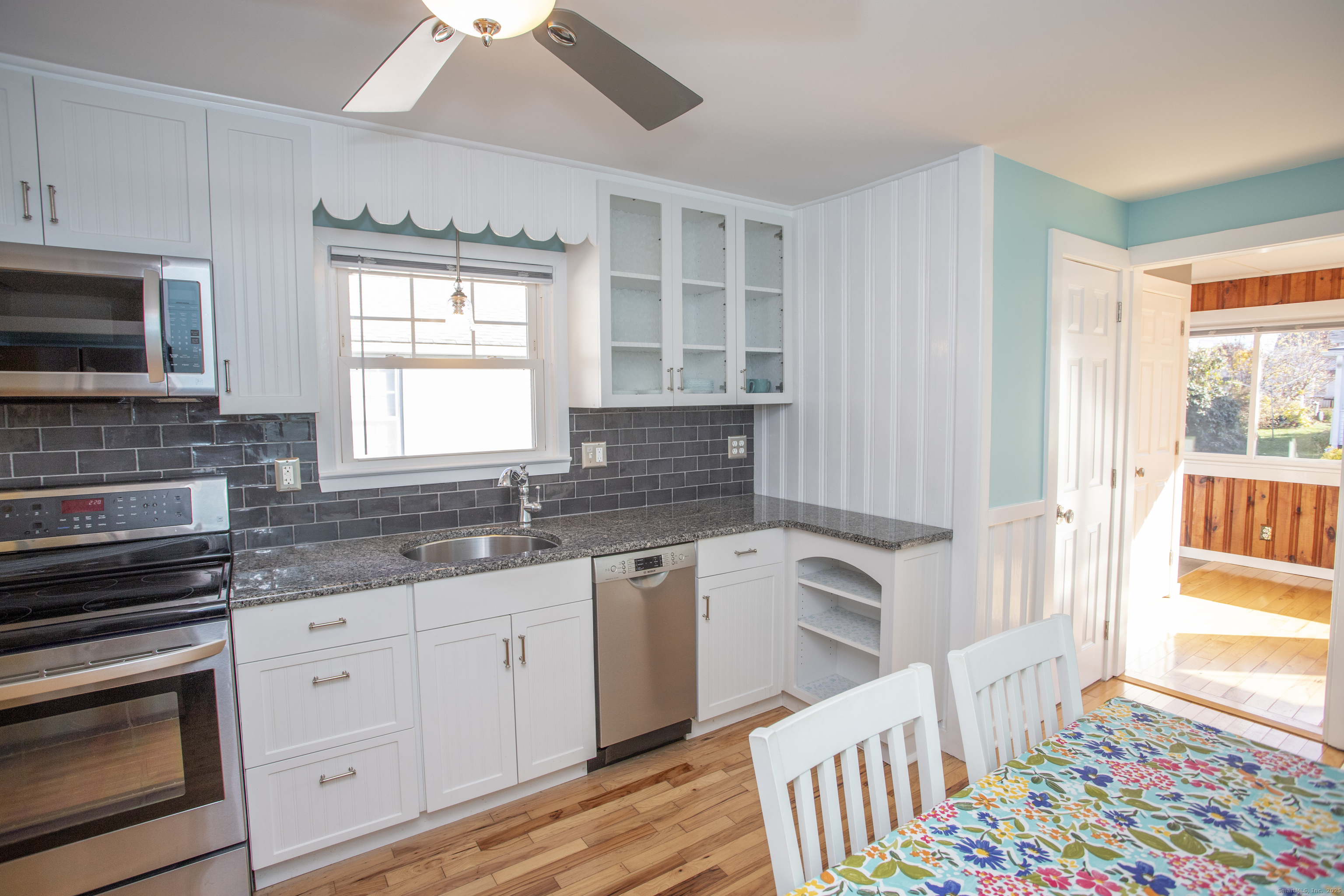 10 Dorothy Road Westbrook, CT 06498 - Photo 8 of 25 a kitchen with granite countertop a stove a sink and a microwave
