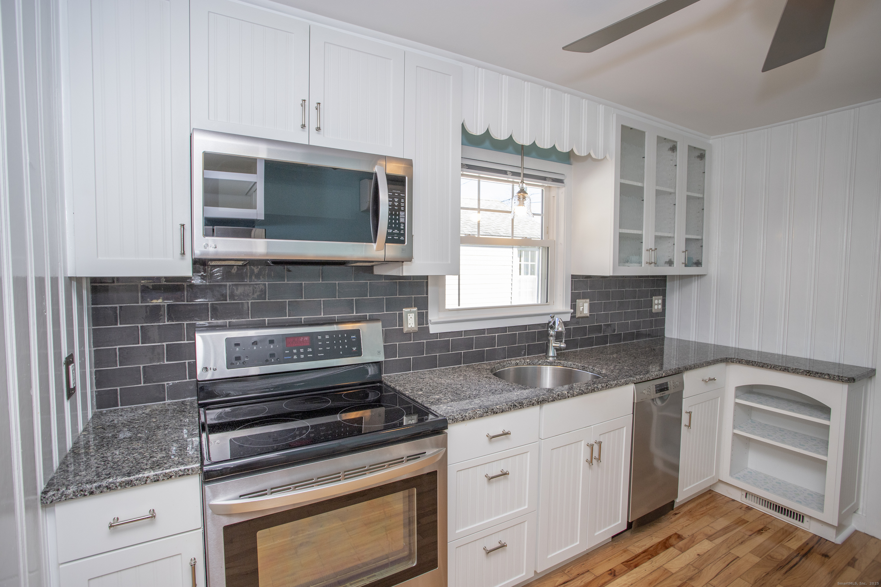 10 Dorothy Road Westbrook, CT 06498 - Photo 9 of 25 a kitchen with granite countertop a stove sink and microwave
