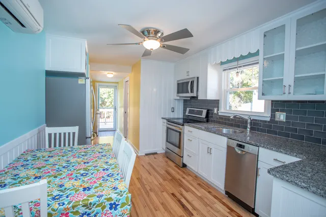 a kitchen with kitchen island a sink appliances and cabinets