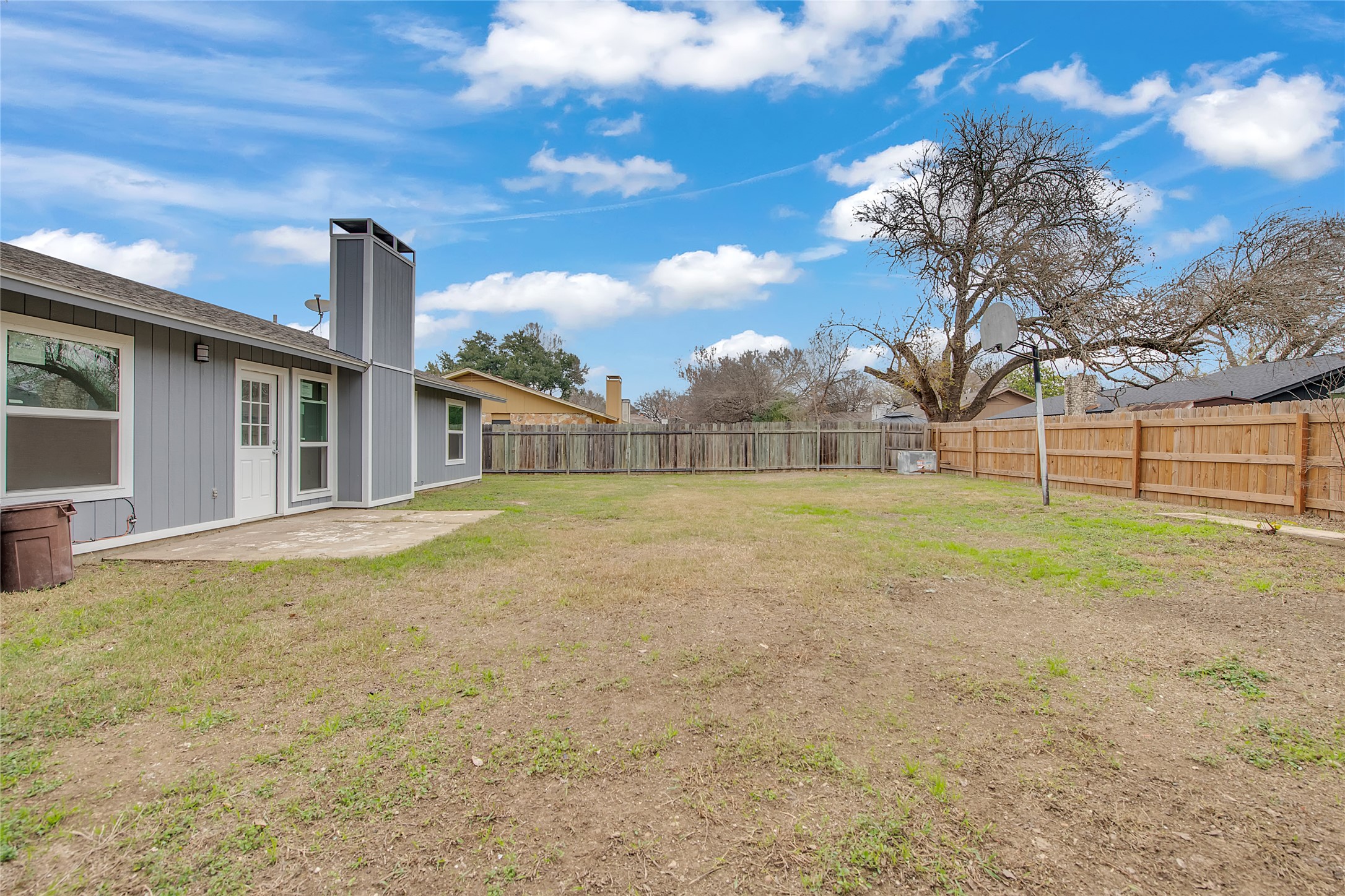 7209 Gunnison Pass Austin, TX 78724 - Photo 18 of 19 A spacious yard bordered by a wooden fence offers ample room for outdoor activities.