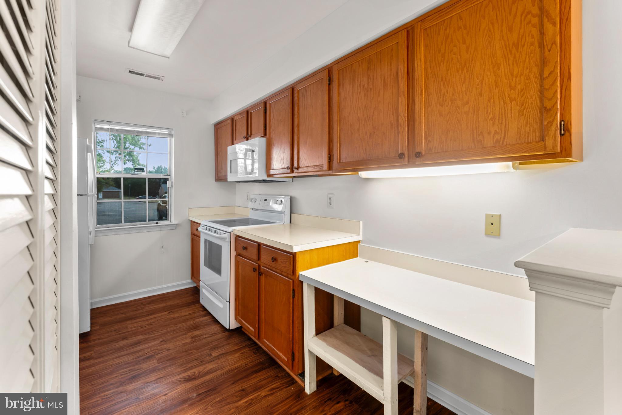 9266 Cherry Lane, Unit 51 Laurel, MD 20708 - Photo 12 of 23 Bright kitchen with warm wood accents.