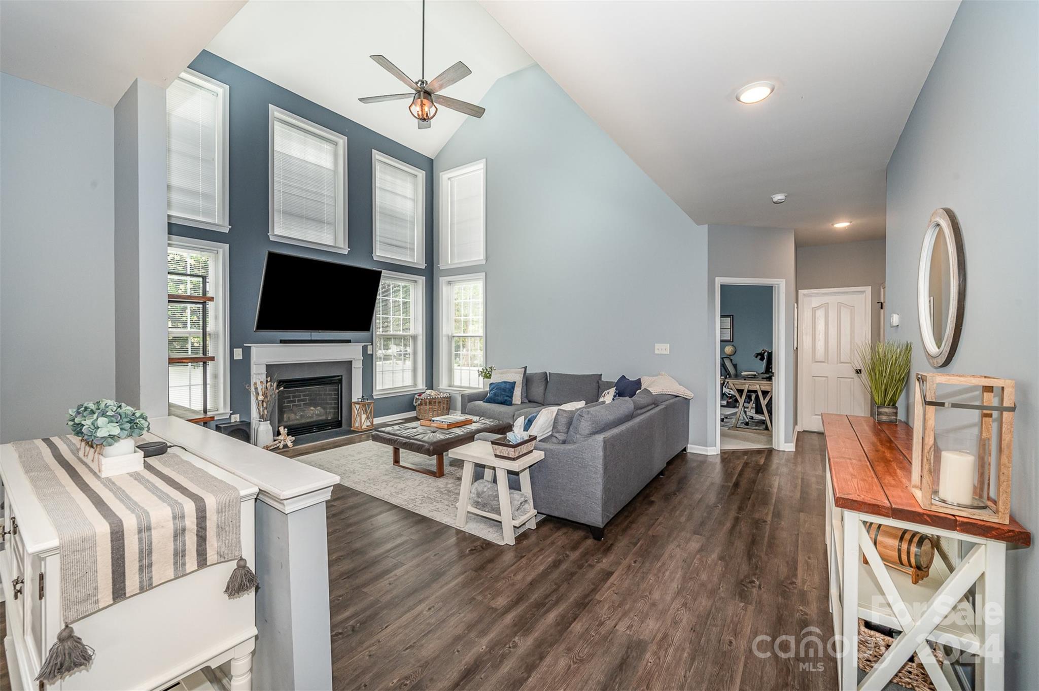 4340 Sunset Rose Drive Fort Mill, SC 29708 - Photo 8 of 26 a living room with furniture a fireplace and a flat screen tv