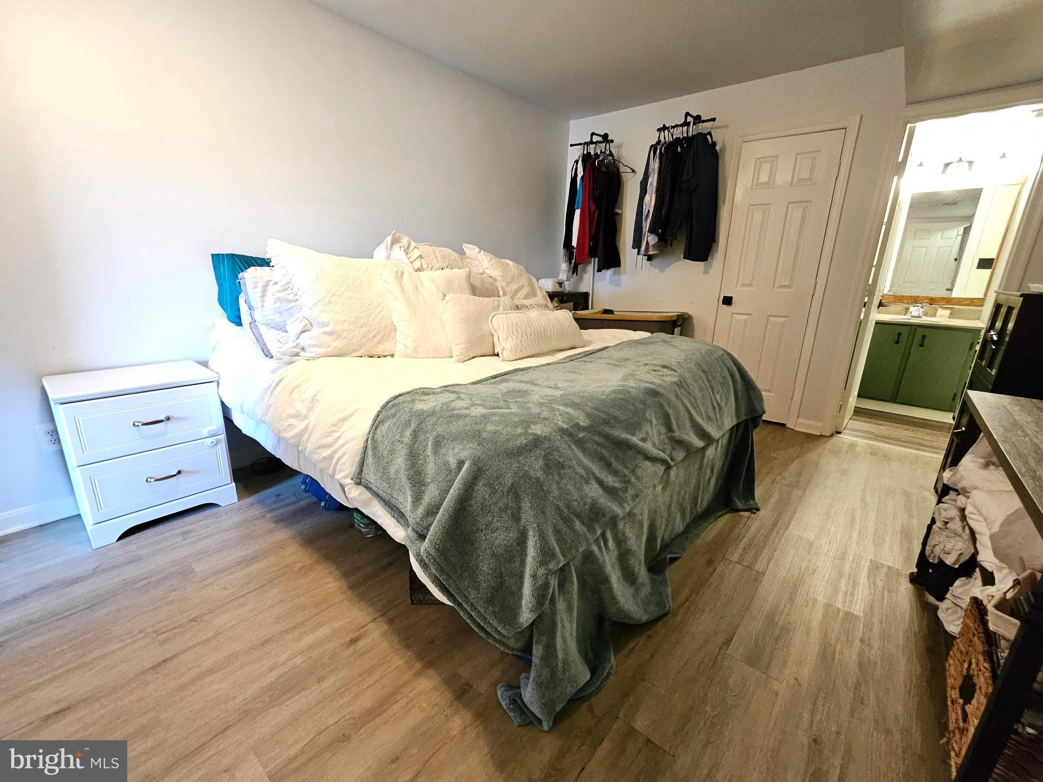 9200 Azure Court, Unit 201 Manassas, VA 20110 - Photo 15 of 20 a bed sitting in a bedroom next to a window with pc on the wall