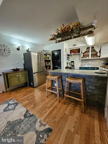 a kitchen with stainless steel appliances granite countertop a refrigerator and stove top oven