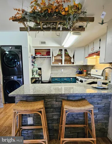 a kitchen with stainless steel appliances granite countertop a stove and cabinets