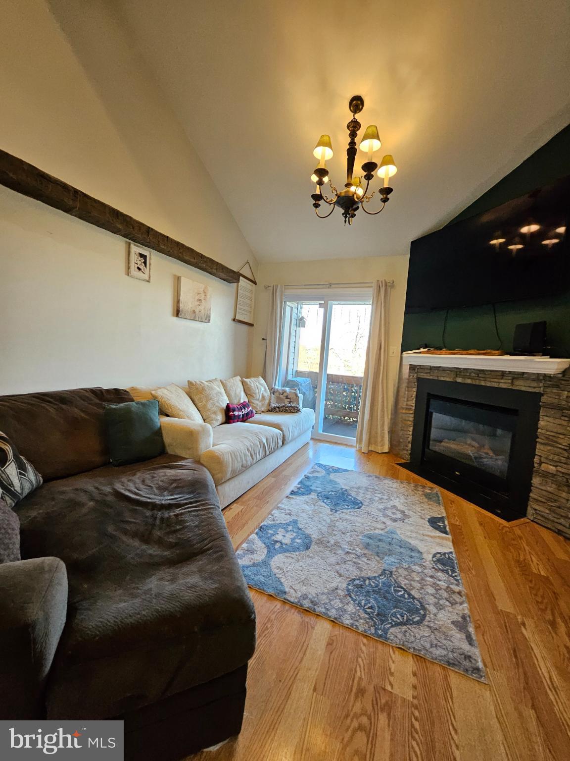 9200 Azure Court, Unit 201 Manassas, VA 20110 - Photo 9 of 20 a living room with furniture a fireplace and a flat screen tv