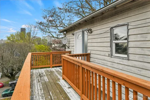 a view of balcony with wooden floor and fence