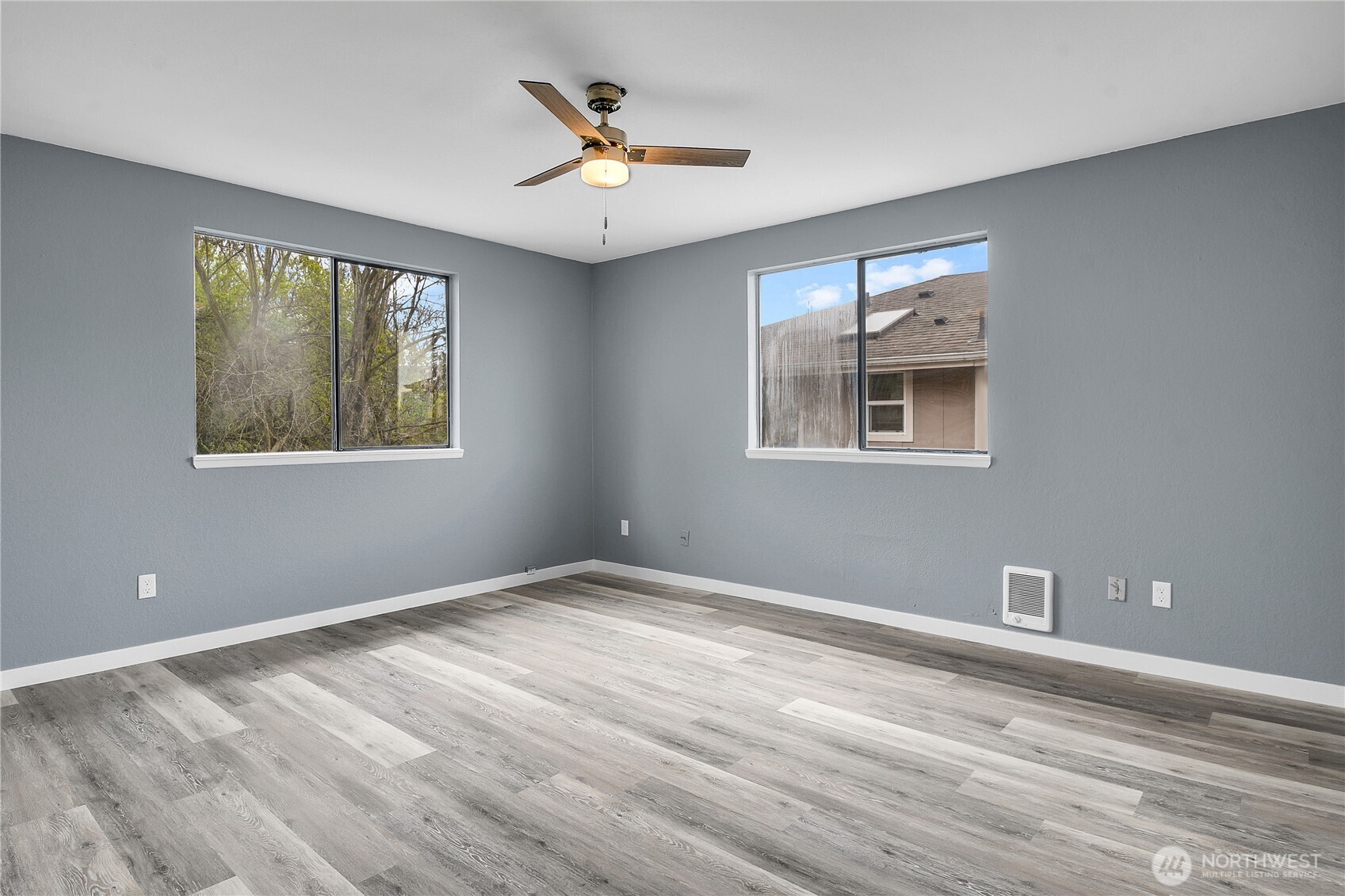 338 16th Avenue, Unit B Seattle, WA 98122 - Photo 4 of 7 a view of an empty room with a window and wooden floor